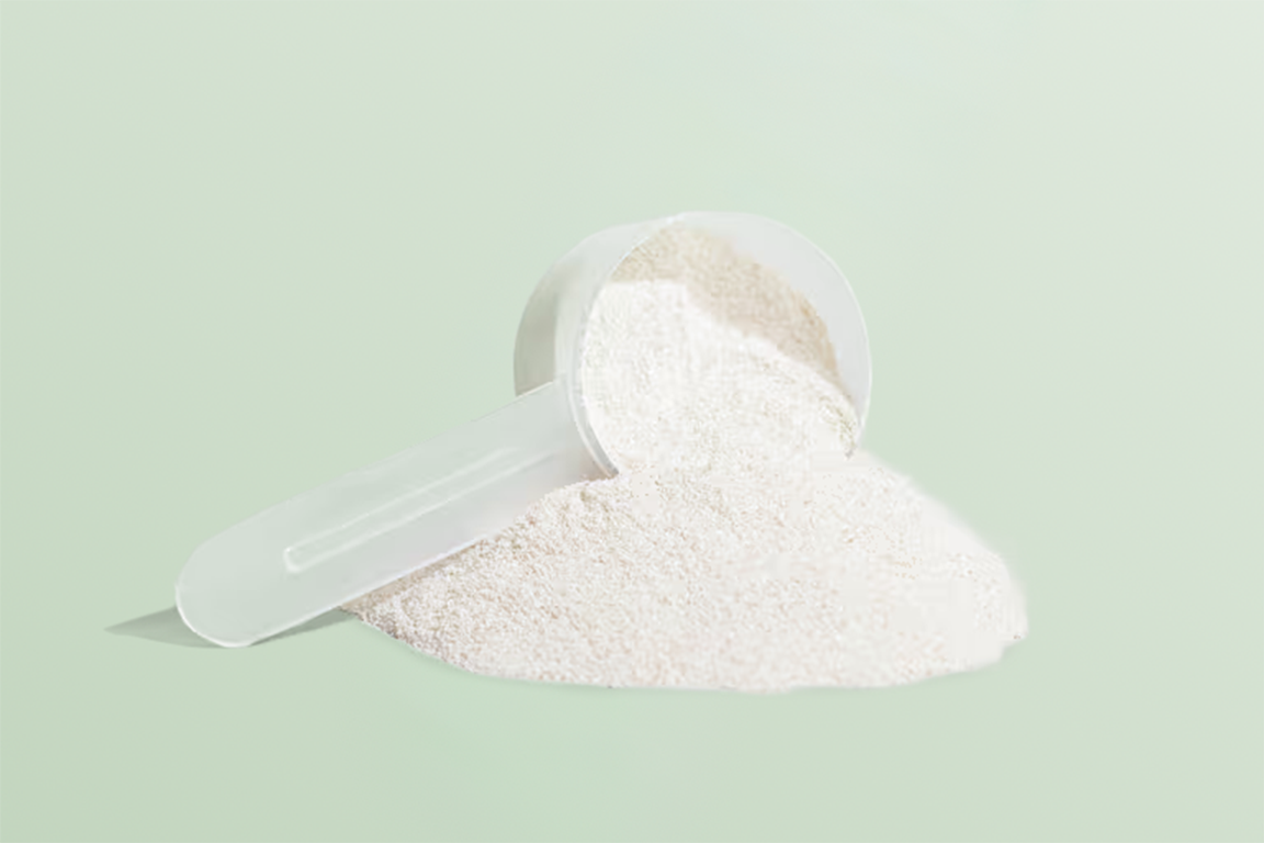 Scoop of Sukina Apothecary Qi Renewal Collagen Peptides Powder showing fine unflavored collagen texture.